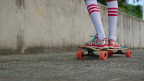 Child on Skateboard Riding Away from Camera