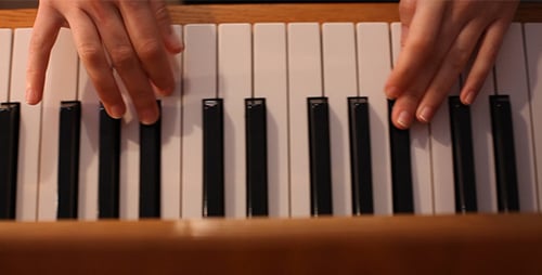 Hands Play Classical Music on Light Colored Piano