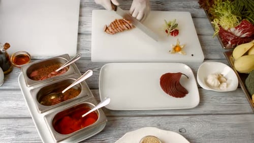 Chef Cuts Meat on Cutting Board in Kitchen