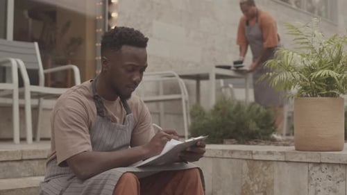 Service Industry Workers Preparing Outdoor Dining Space