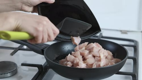 Cooking chicken meat.