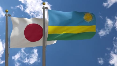 Japan and Rwanda Flags Waving on Flagpoles
