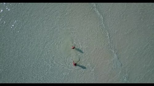 Teenage lovers tan on paradise tourist beach trip by blue water with white sandy background of the M
