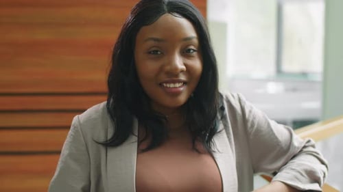 Confident Woman Smiling in Modern Office Building