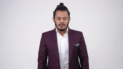 Man Standing Relaxed in a Suit With Eyes Closed