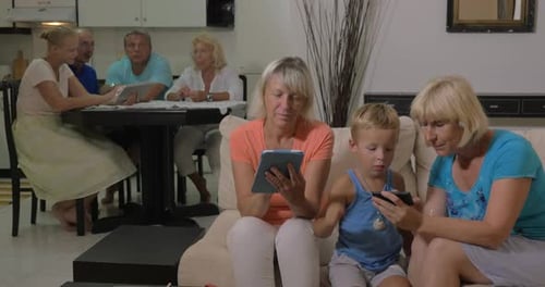 Family Using Mobile Devices in Bright Living Room