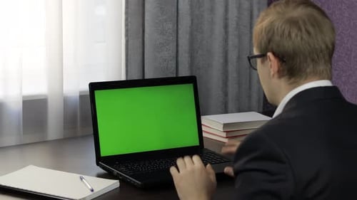 Man Have Video Call Conference on Laptop with Green Screen. Distance Work Online