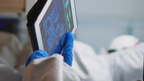 Vertical Video Scientist in Coverall Analyzing Virus Evolution Looking on Digital Tablet