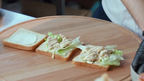 Chef Making Chicken and Cheese Sandwich in Restaurant