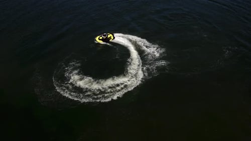 Drohnenaufnahme eines Mannes, der ein persönliches Wasserfahrzeug auf dem See fährt