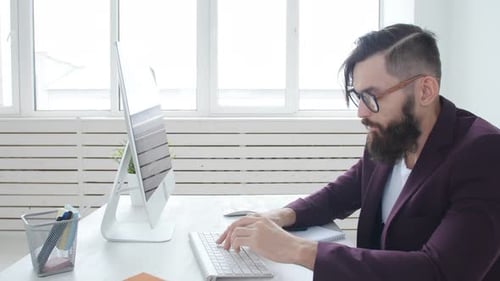 Concept of Freelancing and Work Office. Young Stylish Employee Looking at Computer Monitor During