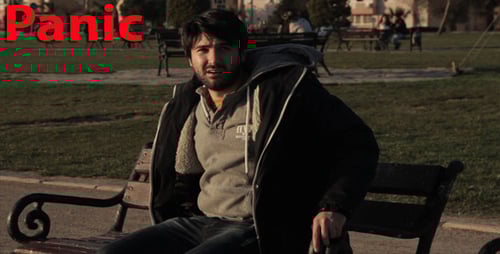 Young Adult Sitting on Park Bench Alone