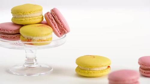 Yellow and Pink Macarons on Glass Stand and Table