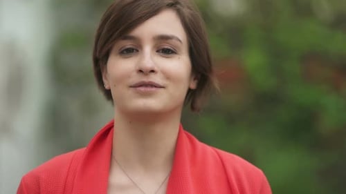 Smiling Woman Portrait in Front of Green Background