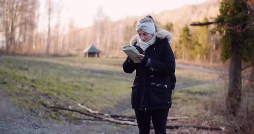 Woman Examining Map in Nature