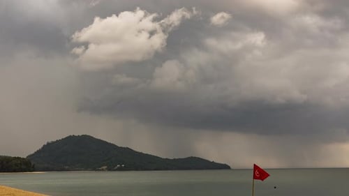 Stormy Beach with Rain Showers and Island