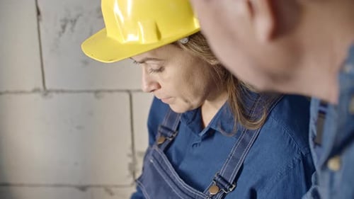 Construction Laborers Discussing Layout Plan