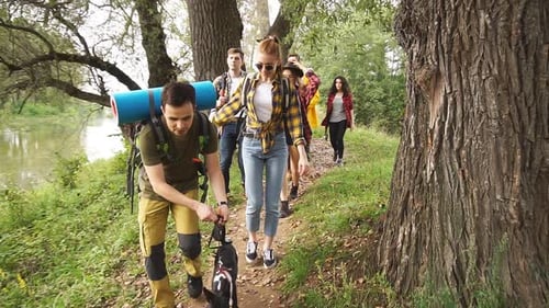 Friends Hiking with Dog in Rural Nature Setting