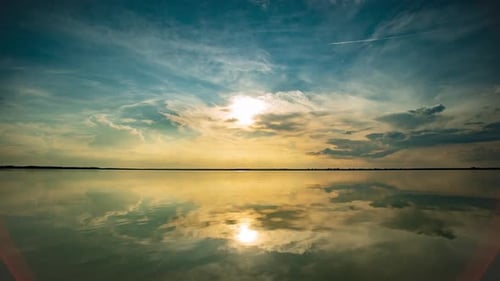 Time Lapse Light Stretched Clouds Over Evening Sky Lake Sunset Skies Reflex on Flat Water