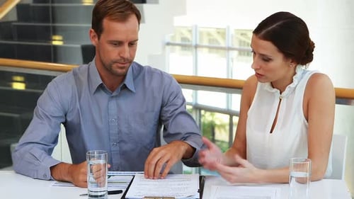Business Professionals Reviewing Documents at Modern Office
