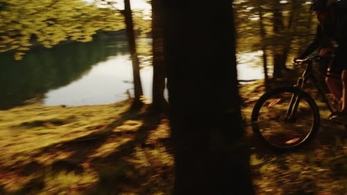 Boy with Mountain Bike By the Lake at Sunset