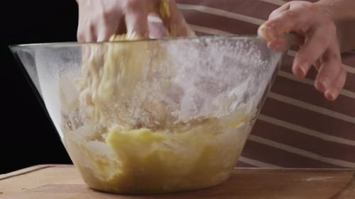 Woman Mixing Dough in Glass Bowl