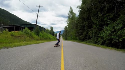 Man rides a skateboard on the road
