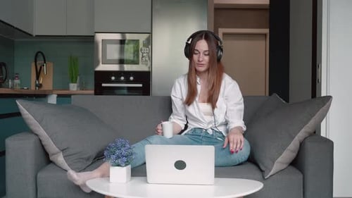 Smiling Woman Video Conferencing with Laptop at Home