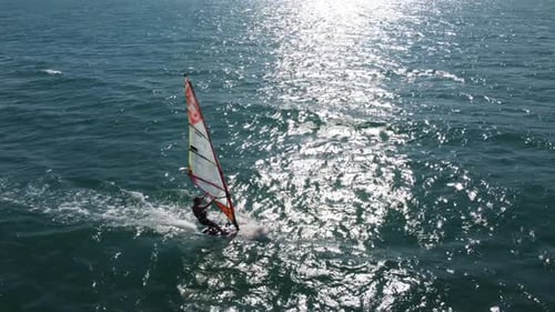 Skiing Windsurfing in the Sea at Sunset