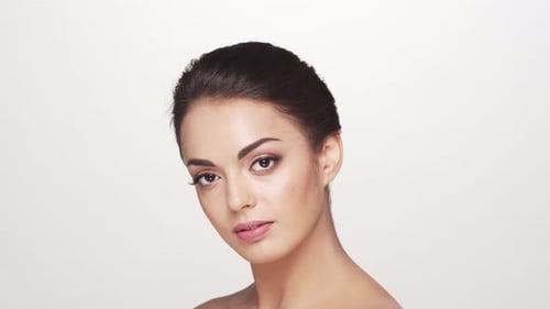 Studio portrait of young and beautiful brunette woman over