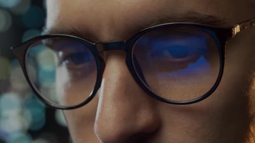 Close-up portrait of a young man working at the computer.
