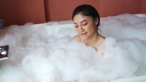 Woman Relaxes in a Luxurious Bubble Bath