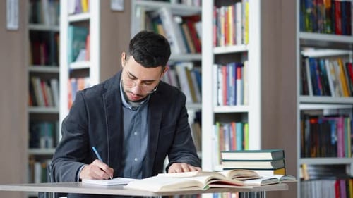Student Doing Scientific Research in Library and Speaking Aloud