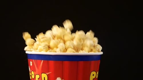Popcorn in Box Falling, on Black, Slow Motion