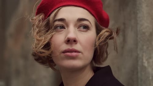 Woman in Red Beret Poses in Urban Setting