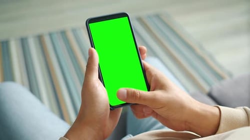 Male Palms Holding Smartphone with Mock-up Green Screen Touching with Fingers