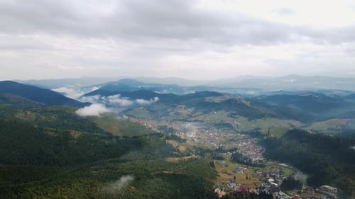 Scenic Aerial View of Town Nestled in Mountains