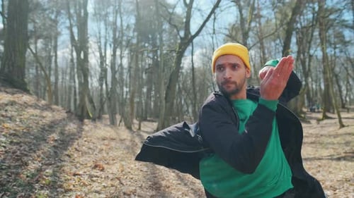 Professional Young Dancer in a Yellow Hat Is Dancing in the Wood. Nice Hipster Guy Outdoors.
