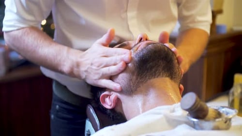 Barber Giving Soothing Facial Massage to Customer