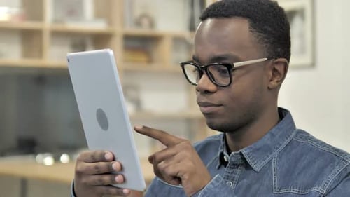 Young Adult Using Tablet Device Indoors