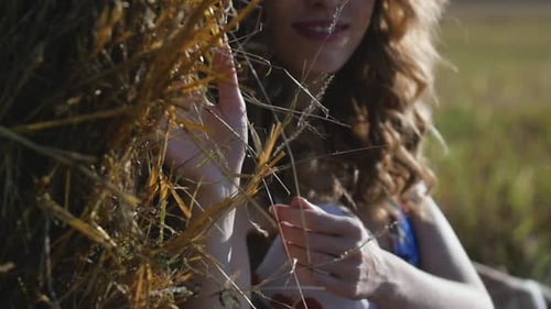 Closeup Portrait of Attractive Young Redhead Woman Sitting Near Hay