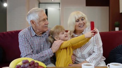 Grandparents and Grandchild Taking Selfie with Smartphone