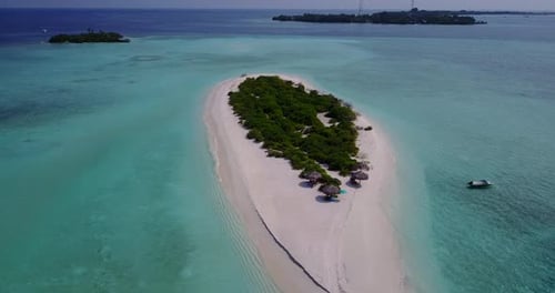 Luxury birds eye tourism shot of a sunshine white sandy paradise beach and blue water background in
