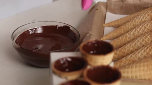 Chocolate being added to Waffle Cones and Bowls