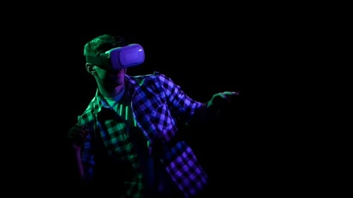 Man Playing Online Games in Virtual Reality Glasses. Black Studio