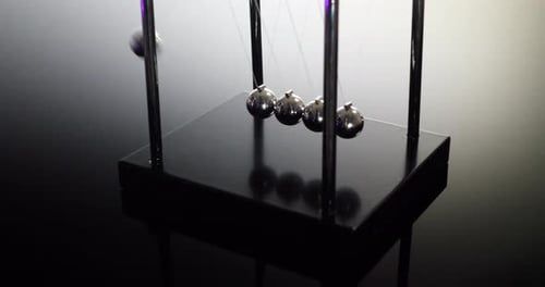 Swinging Newton's Cradle Demonstrating Kinetic Energy