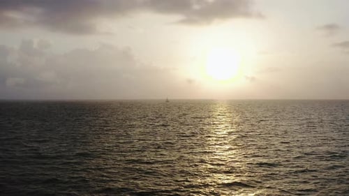 Aerial Drone Shot of Yacht Sails in the Sea or Ocean at an Amazing Sunset