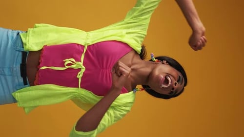 Young Woman Dancing in Colorful Fashion