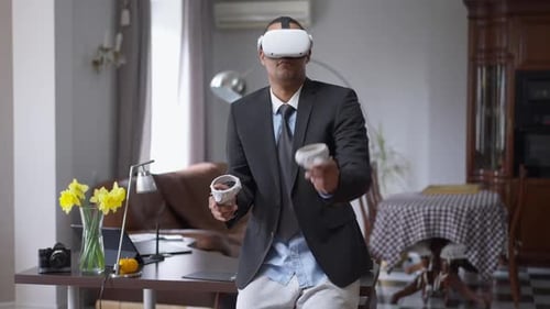 Positive Young African American Man in VR Headset Having Break in Home Office on Coronavirus
