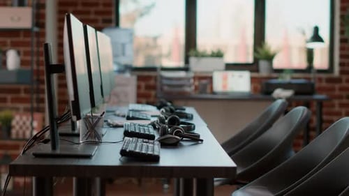Empty Call Center Workstation with Headsets and Computers
